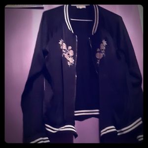 Jacket with flowers and black and white stripes.
